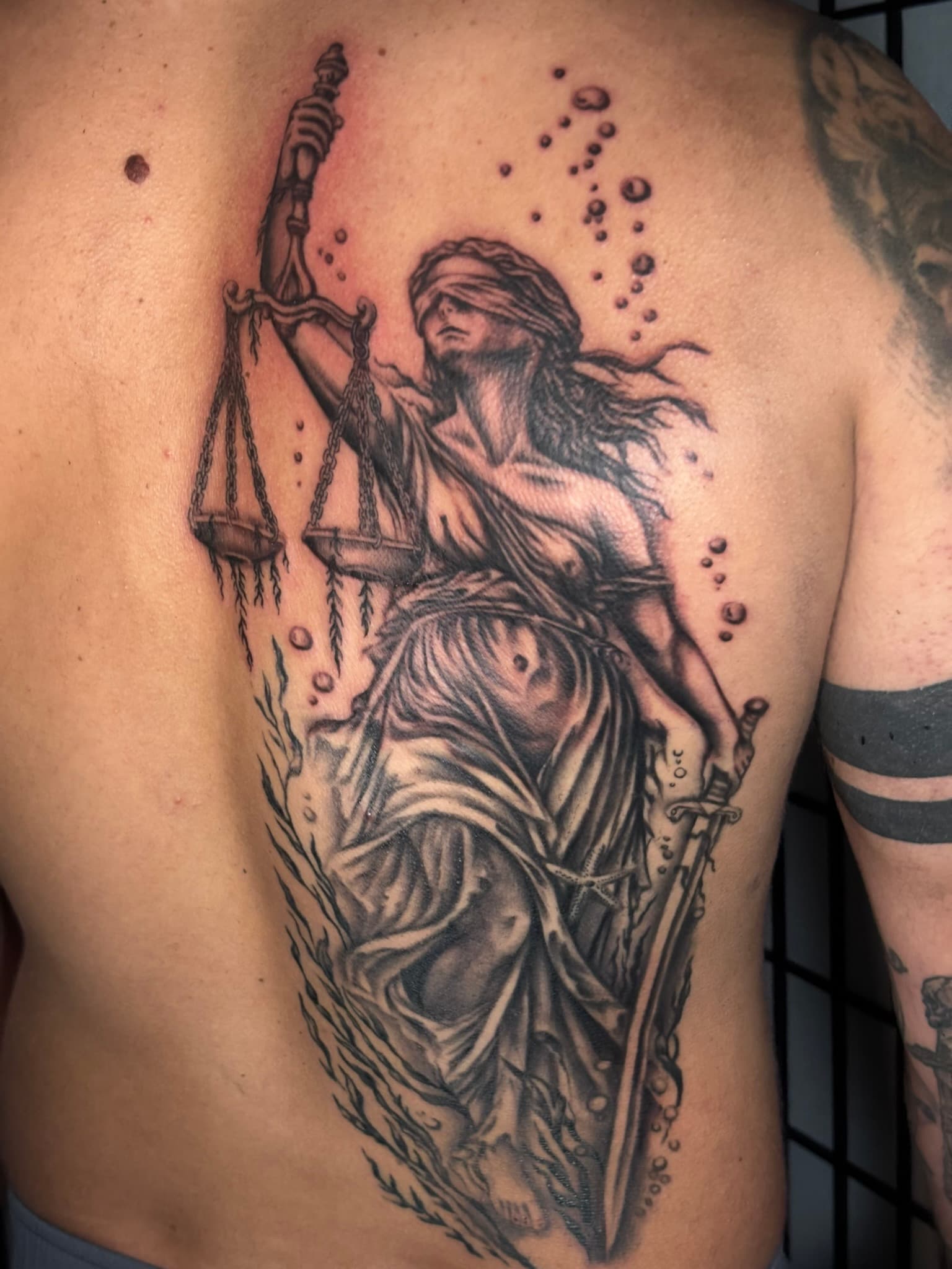Realism underwater Lady Liberty back piece tattoo